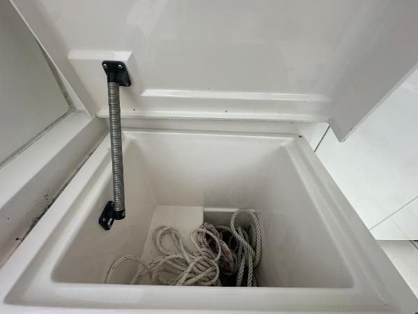 Slide: The Image of Open storage compartment with rope on a 1993 Luhrs 320 Tournament boat. - 12