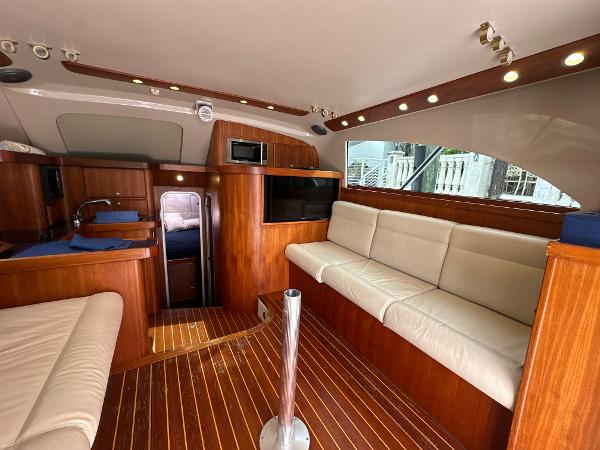 Slide: The Image of Luxurious interior of 1993 Luhrs 320 Tournament yacht with wood finish and comfortable seating. - 14