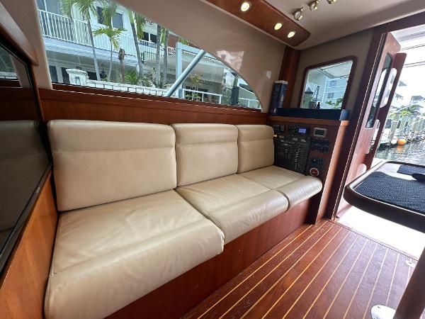 Slide: The Image of 1993 Luhrs 320 Tournament interior with beige leather seating and wood flooring. - 16