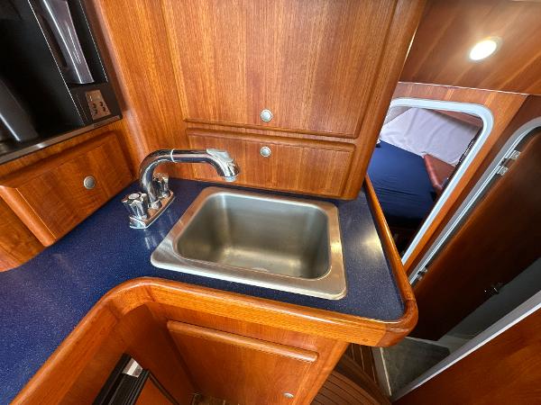 Slide: The Image of 1993 Luhrs 320 Tournament yacht interior with wooden cabinetry and stainless steel sink. - 22