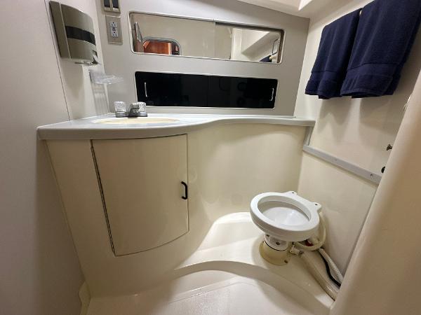 Slide: The Image of 1993 Luhrs 320 Tournament boat bathroom with sink, mirror, and toilet. - 23