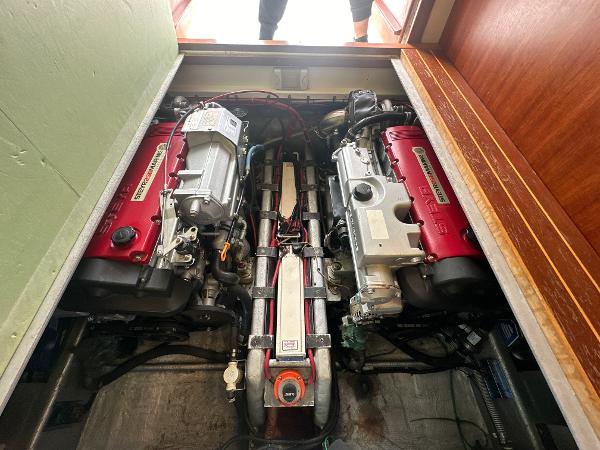 Slide: The Image of 1993 Luhrs 320 Tournament engine compartment with twin engines, showcasing detailed mechanical components. - 24