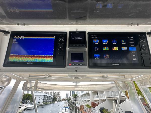 Slide: The Image of 1993 Luhrs 320 Tournament boat dashboard with Garmin navigation displays. - 28