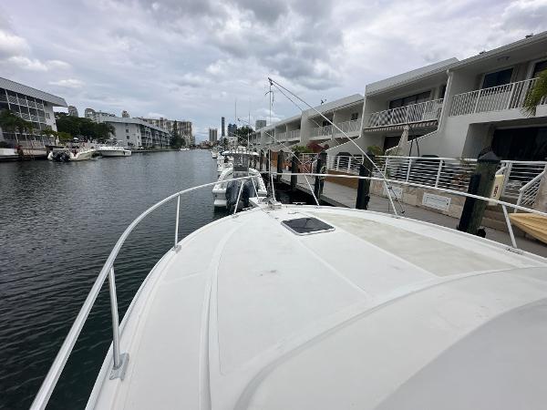 Slide: The Image of 1993 Luhrs 320 Tournament boat docked in a marina with cloudy skies. - 30