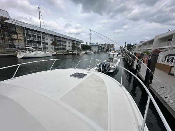 Slide: The Image of 1993 Luhrs 320 Tournament boat docked in a marina under cloudy skies. - 31