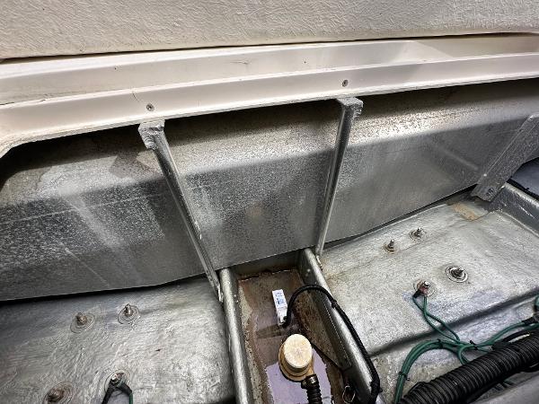 Slide: The Image of Engine compartment of a 1993 Luhrs 320 Tournament boat, showing metal components and wiring. - 34