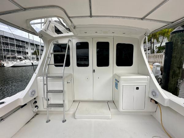 Slide: The Image of 1993 Luhrs 320 Tournament boat interior with ladder and storage, docked at marina. - 6