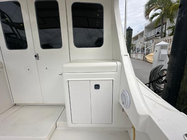 Slide: The Image of 1993 Luhrs 320 Tournament boat interior with white cabinetry and dockside view. - 7