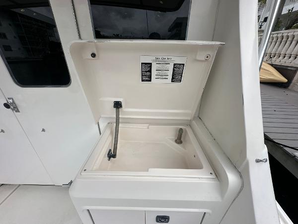 Slide: The Image of 1993 Luhrs 320 Tournament boat sink with open lid and faucet. - 8