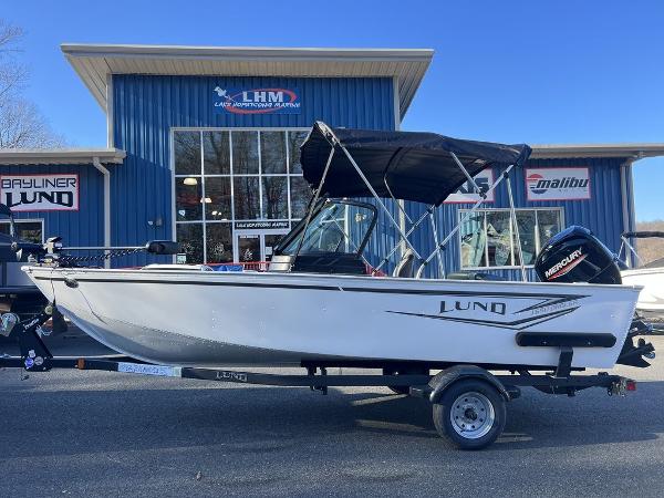 Slide: The Image of 2024 Lund 1650 Angler Sport boat on trailer outside dealership. - 1