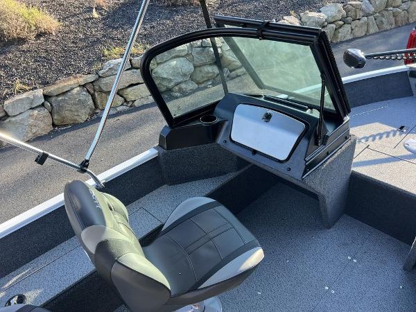 Slide: The Image of 2024 Lund 1650 Angler Sport boat interior with seating and windshield. - 7