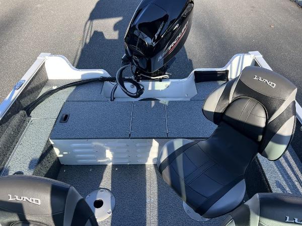 Slide: The Image of 2024 Lund 1650 Angler Sport boat interior with motor and seating. - 8