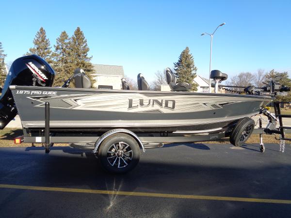 Slide: The Image of 2024 Lund 1875 Pro Guide fishing boat on trailer in parking lot. - 11