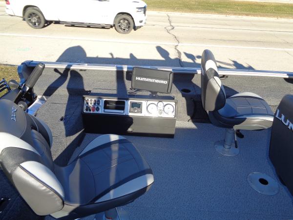 Slide: The Image of 2024 Lund 1875 Pro Guide boat interior with Humminbird electronics and seating. - 13