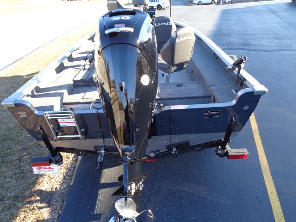 Slide: The Image of 2024 Lund 1875 Pro Guide fishing boat with outboard motor, rear view. - 16