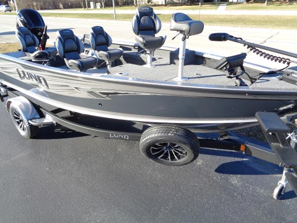 Slide: The Image of 2024 Lund 1875 Pro Guide fishing boat on trailer, featuring multiple seats and a sleek design. - 17