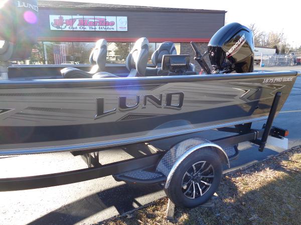 Slide: The Image of 2024 Lund 1875 Pro Guide fishing boat on trailer with Mercury outboard motor. - 21