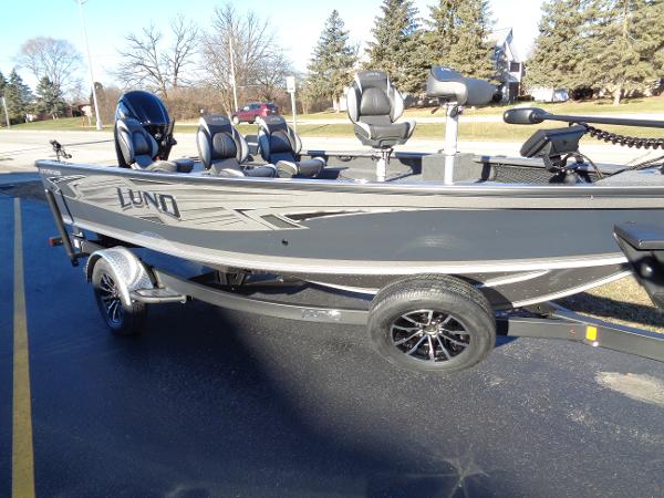 Slide: The Image of 2024 Lund 1875 Pro Guide fishing boat on a trailer in a parking lot. - 5