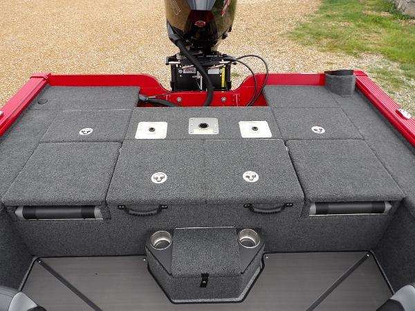 Slide: The Image of 2024 Lund 2075 Pro-V Bass XS boat interior with storage compartments and motor. - 15
