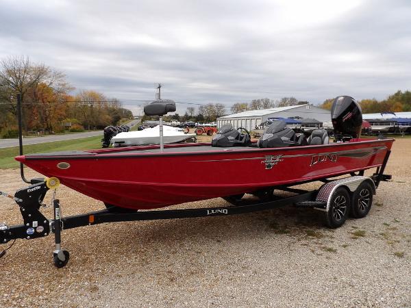 Slide: The Image of 2024 Lund 2075 Pro-V Bass XS boat in red on a trailer. - 3