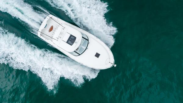 Slide: The Image of 2023 Mag Bay 42 Express yacht cruising on open water, aerial view. - 10