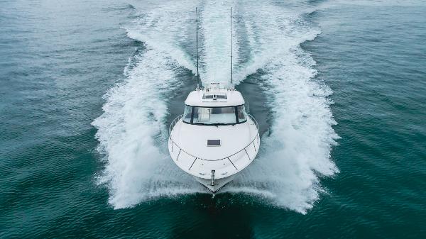 Slide: The Image of 2023 Mag Bay 42 Express cruising on open water, creating a dynamic wake. - 12