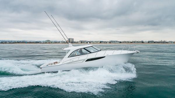 Slide: The Image of 2023 Mag Bay 42 Express yacht cruising on open water under cloudy skies. - 14