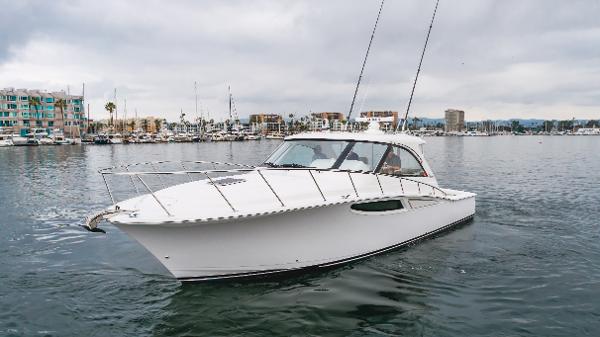 Slide: The Image of 2023 Mag Bay 42 Express yacht cruising in a marina under cloudy skies. - 23