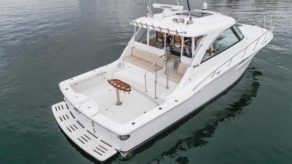 Slide: The Image of 2023 Mag Bay 42 Express boat on calm water, showcasing sleek design and spacious deck. - 30