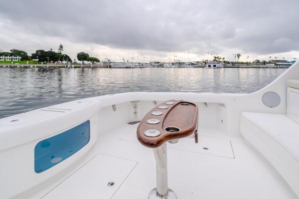 Slide: The Image of 2023 Mag Bay 42 Express boat deck with rod holders, overlooking a calm marina. - 39