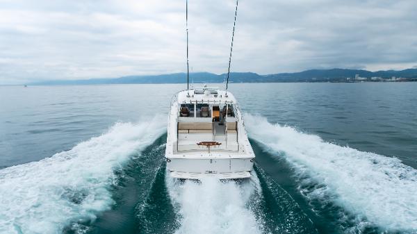 Slide: The Image of 2023 Mag Bay 42 Express cruising on open water, rear view. - 4