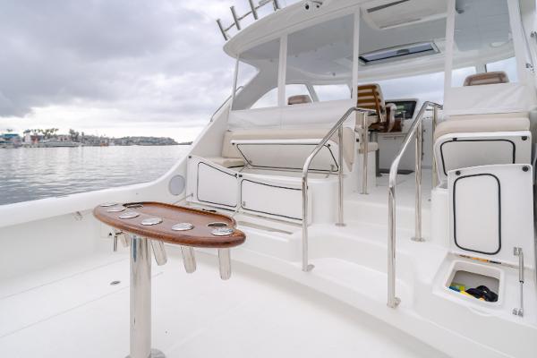 Slide: The Image of 2023 Mag Bay 42 Express yacht deck with seating and table, overlooking calm waters. - 40