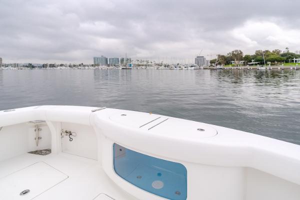 Slide: The Image of 2023 Mag Bay 42 Express boat on calm waters with cityscape background. - 41