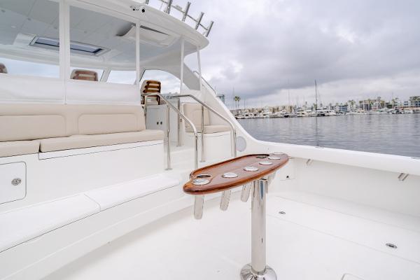 Slide: The Image of 2023 Mag Bay 42 Express yacht interior with seating and rod holders, docked in a marina. - 42
