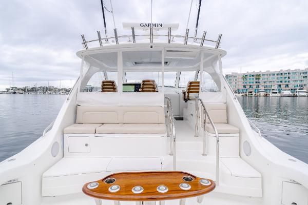 Slide: The Image of 2023 Mag Bay 42 Express yacht interior with seating and Garmin equipment, docked in marina. - 43