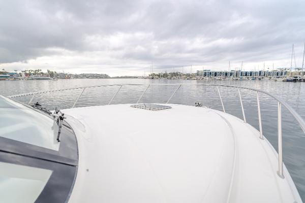 Slide: The Image of 2023 Mag Bay 42 Express yacht on calm waters under cloudy skies. - 44