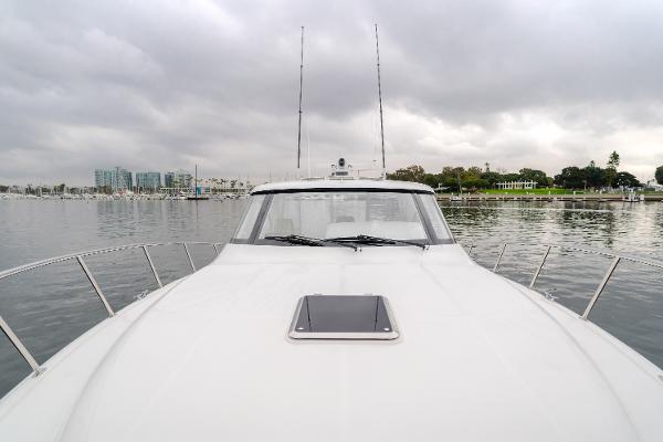 Slide: The Image of 2023 Mag Bay 42 Express yacht on calm waters under cloudy skies. - 45