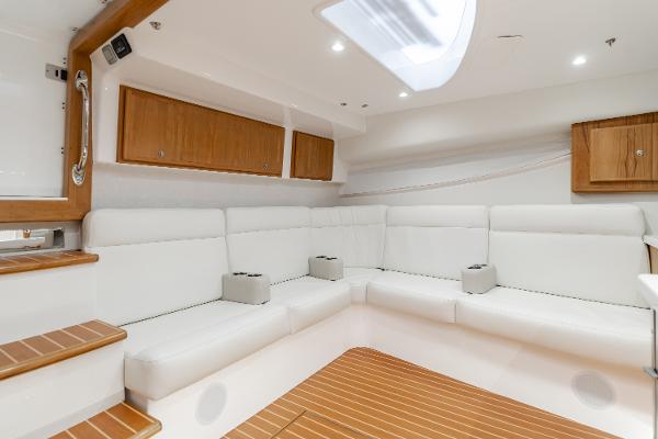 Slide: The Image of Luxurious interior of 2023 Mag Bay 42 Express yacht with white seating and wooden accents. - 48