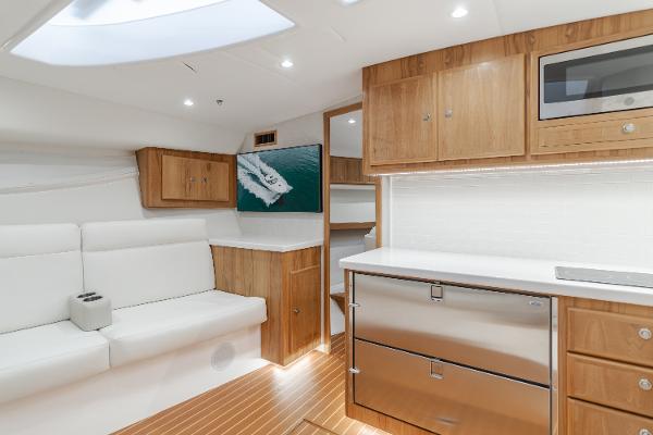 Slide: The Image of Luxurious interior of 2023 Mag Bay 42 Express yacht with modern wood cabinetry and seating. - 49