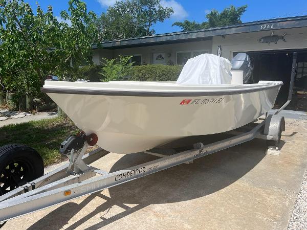 Slide: The Image of 1988 Mako 171 Center Console boat on a trailer in a driveway. - 0