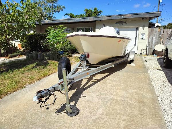Slide: The Image of 1988 Mako 171 Center Console boat on trailer in driveway. - 13