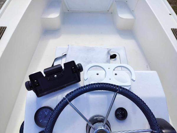 Slide: The Image of 1988 Mako 171 Center Console boat interior with steering wheel and instrument panel. - 29