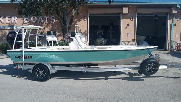 Slide: The Image of 2022 Mako 18 LTS boat on a trailer outside a boat dealership. - 1