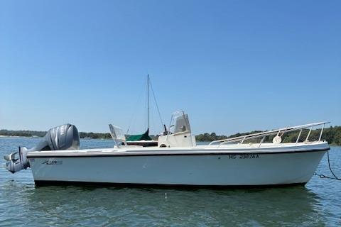 Slide: The Image of 1989 Mako 191CC boat on water, clear sky, side view. - 1