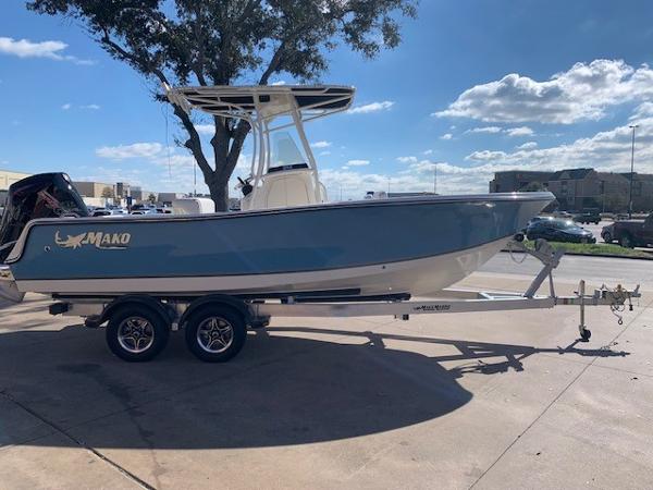 Slide: The Image of 2024 Mako 214 CC boat on a trailer in a parking lot. - 0