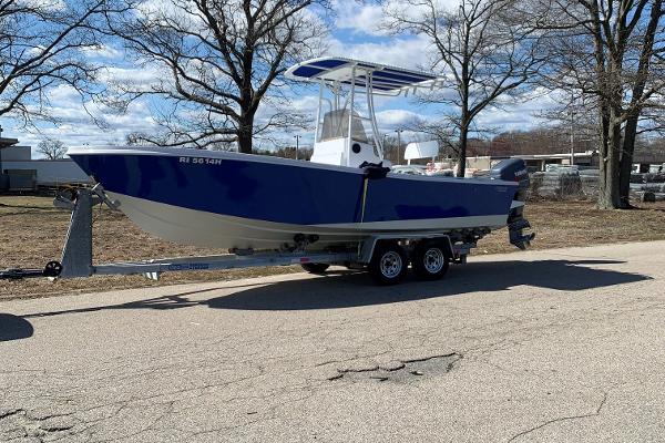 Slide: The Image of 1980 Mako 23 boat on trailer, parked outdoors under clear sky. - 1
