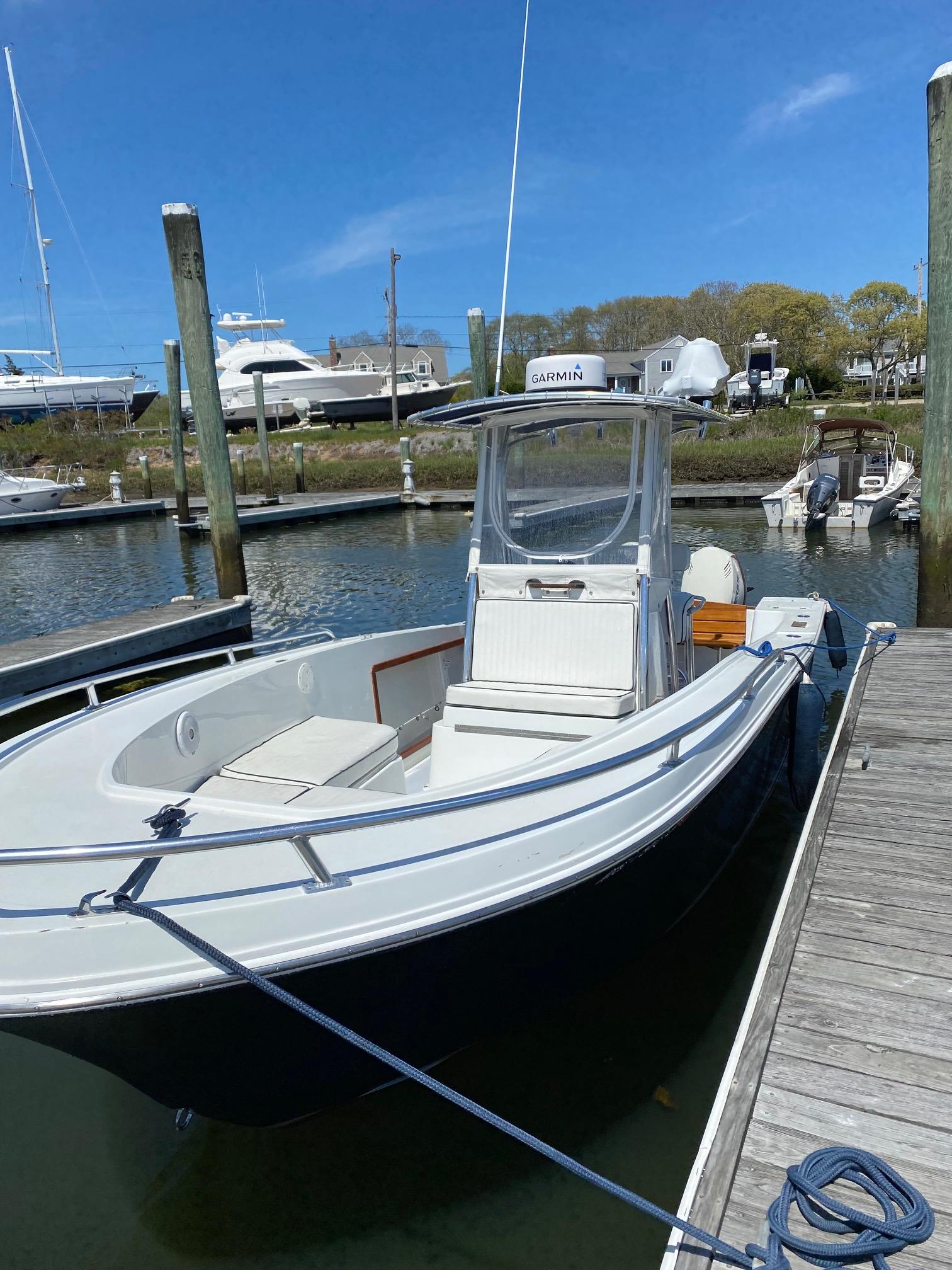 Slide: The Image of 1991 Mako 241 boat docked at marina under clear blue sky. - 3