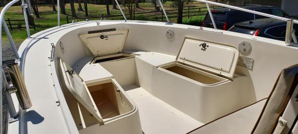Slide: The Image of 1990 Mako 261 Center Console boat with open storage compartments on deck. - 9