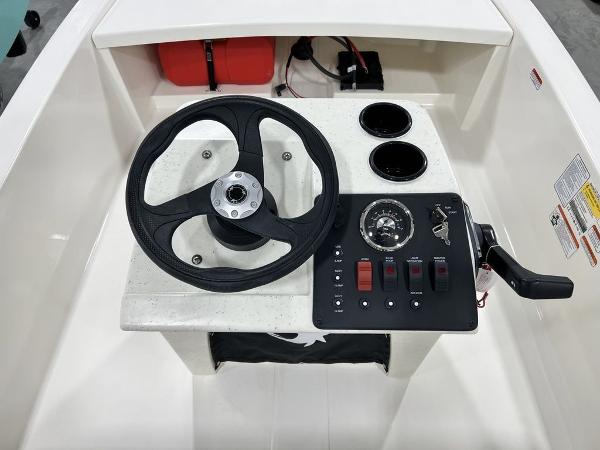 Slide: The Image of 2023 Mako Pro Skiff 13 CC center console with steering wheel and control panel. - 10