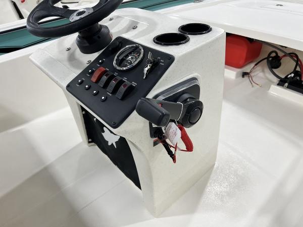 Slide: The Image of 2023 Mako Pro Skiff 13 CC console with steering wheel, gauges, and controls. - 11
